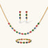 Gold-plated jewelry set with red, green, and blue cubic zirconia stones including necklace, bracelet, and drop earrings.