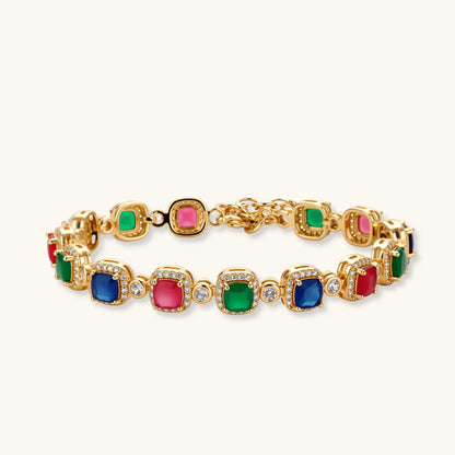 Gold-plated jewelry set with red, green, and blue cubic zirconia stones including necklace, bracelet, and drop earrings.