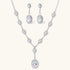 Elegant white gold plated jewelry set with oval cubic zirconia stones in halo settings, featuring Y-necklace and drop earrings.