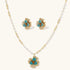 14K gold-plated floral jewelry set with blue cubic zirconia centers and pearl chain details on white background.