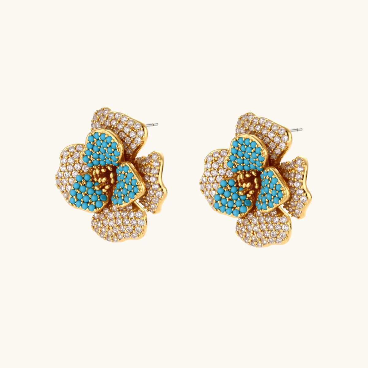 14K gold-plated floral jewelry set with blue cubic zirconia centers and pearl chain details on white background.