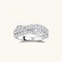 Sterling silver crossover ring with pavé-set moissanite stones creating an elegant infinity design on neutral background