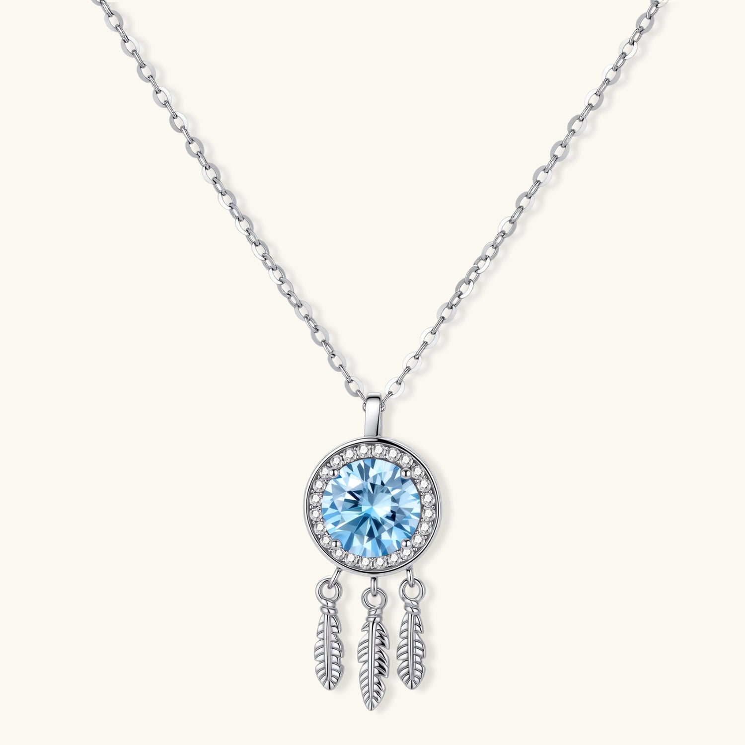Sterling silver dreamcatcher pendant with blue moissanite center and three feather charms on adjustable chain.
