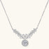 Elegant sterling silver necklace featuring intricate wing-like design with brilliant moissanite stones on neutral background.
