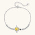 Sterling silver bracelet with yellow moissanite centerpiece in oval setting, crystal chain, and star charm on white background.