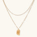 Layered paperclip chain necklace with organic flowing pendant made from eco-zinc alloy in warm gold finish