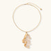 Close-up of a sculptural necklace with flowing wave pendant made from eco-zinc alloy on adjustable chain