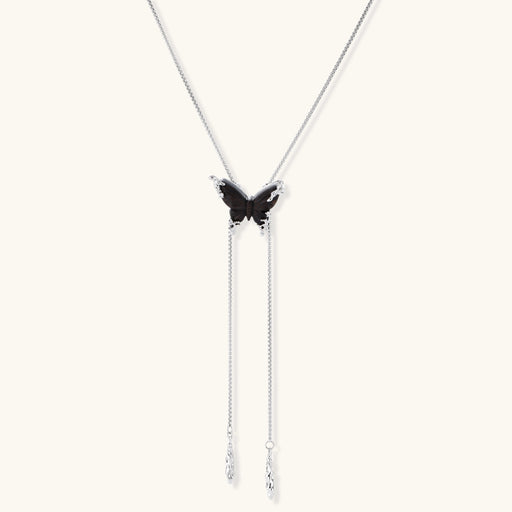 Wooden butterfly pendant necklace with cascading silver-toned chains on adjustable chain, available in amber and black.