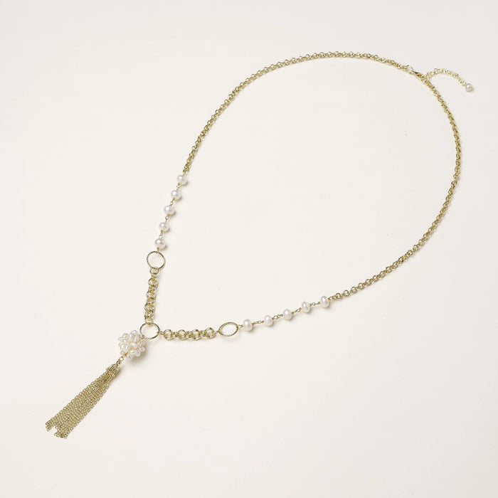 Long gold-plated necklace with freshwater pearls, chunky chain links, and flowing tassel pendant