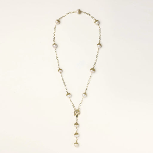 Gold-plated lariat necklace with baroque pearls and textured caps on cream background, showing adjustable Y-shaped design.