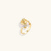 Gold-plated sculptural ring featuring a baroque pearl wrapped in a delicate rose and vine cage design