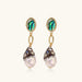 Gold drop earrings with iridescent abalone studs, rope links, jeweled caps and white baroque pearls on cream background