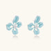 Turquoise enamel flower stud earrings with marbled finish and crystal centers on 18K gold plated brass