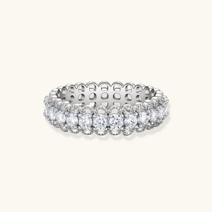 Sterling silver eternity ring with continuous row of brilliant moissanite stones in scalloped crown setting with milgrain detail