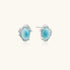 Oval larimar gemstone studs with ornate silver settings showing natural turquoise marbling on cream background