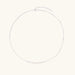 Delicate sterling silver chain necklace with small freshwater pearls arranged in a curved smile arc on cream background.