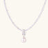 Dainty necklace with lavender crystal beads, freshwater pearls, geometric pendant, and large pearl drop on white background.