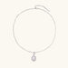 Oval sterling silver pendant with crystal halo surrounding a white freshwater pearl on delicate chain
