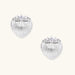 White gold-plated shell-textured stud earrings with three zirconia crystals on ridged surface against cream background.