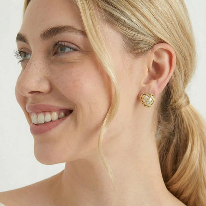 Model wearing gold plated geometric lattice stud earrings