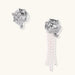 Silver-toned sculptural panther head earrings with zirconia details and white pearl drops on cream background