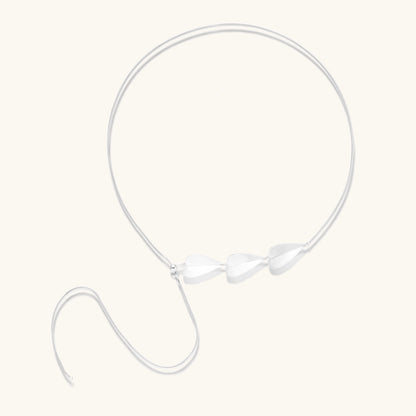 Minimalist sterling silver necklace with three brushed leaf-shaped pendants on delicate chain against white background