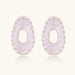Oval lavender enamel earrings with marbled finish and gold-plated beaded border on cream background.