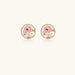Gold-rimmed circular stud earrings with hand-painted pink peony enamel and pearl accents on white background