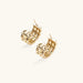 Gold-plated geometric hoop earrings with basket-weave lattice design and pavé crystal accents on cream background