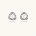 Triangular white gold plated stud earrings with central freshwater pearl and baguette-cut stones on white background