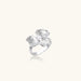 Silver-toned orchid ring with textured petals, pearl center accents, and sparkling zirconia stones on white background.