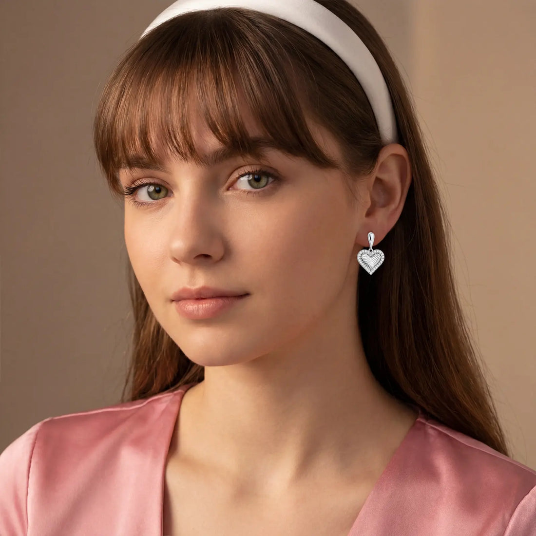Model wearing white gold shell stud earrings with zirconia crystals
